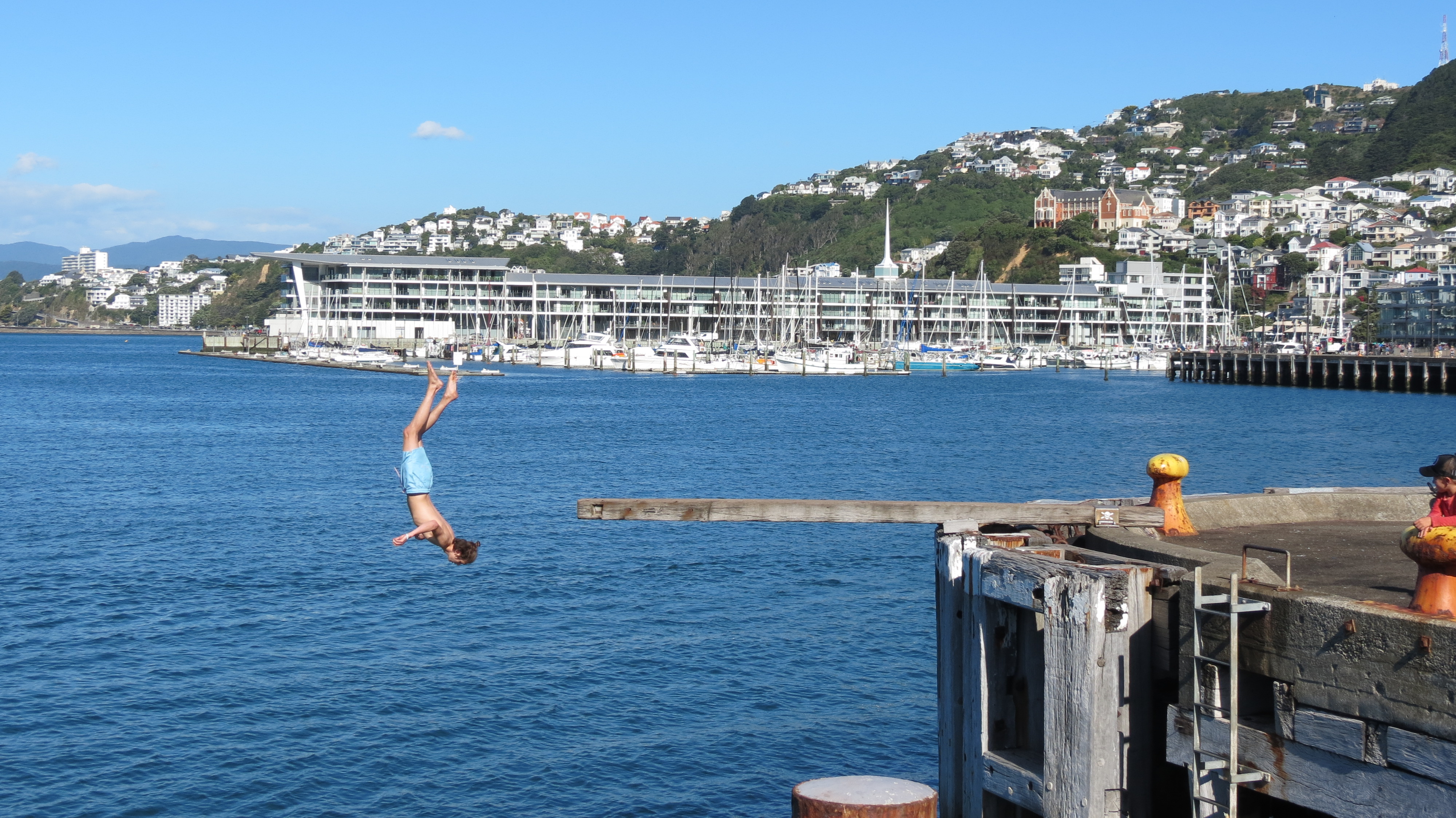 Daniel Ralphs jumping off the wharf in Wellington