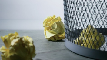 Rubbish bin with paper in it image